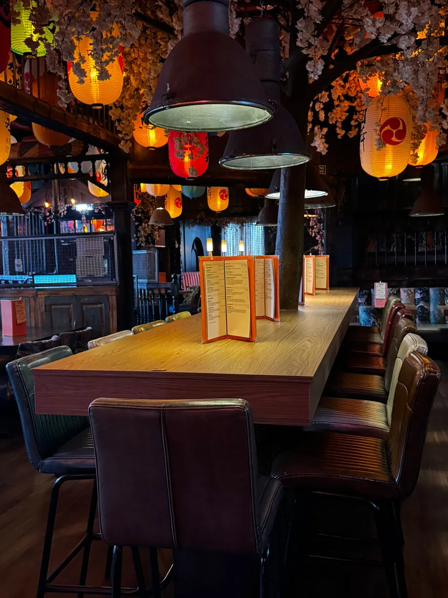 Booths and high tables under the blossom canopy