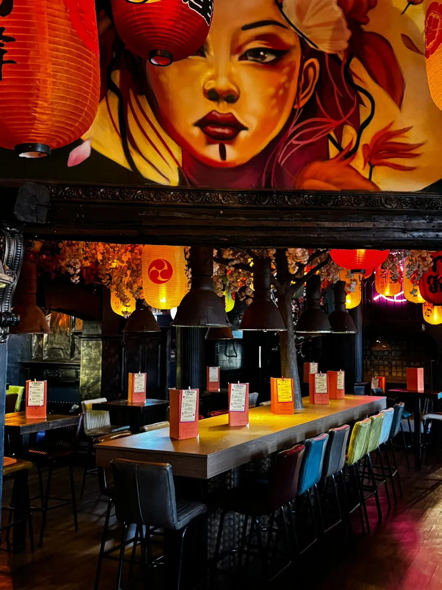 Geisha mural above the bar, under red lanterns